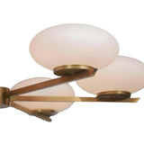 Detailed view of geometric brass arms and opal glass shades on Orion 6 light chandelier.