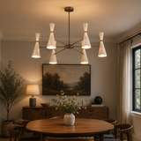Osaka 6 light white double-cone chandelier illuminated above a wooden dining table in a warm Mid-Century Modern dining room.