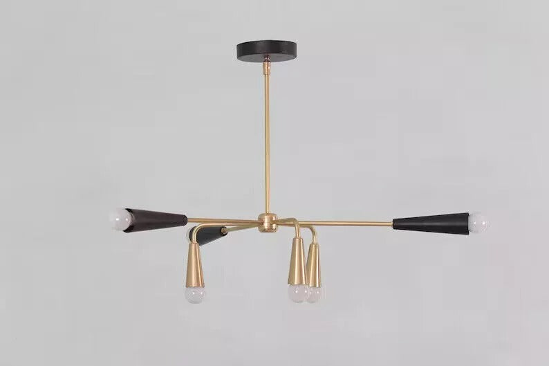 Front view of the Osaka 6-light Mid-Century Modern chandelier featuring black and brass-tone cone holders, exposed white globe bulbs, slender metal arms, and a round black ceiling canopy.