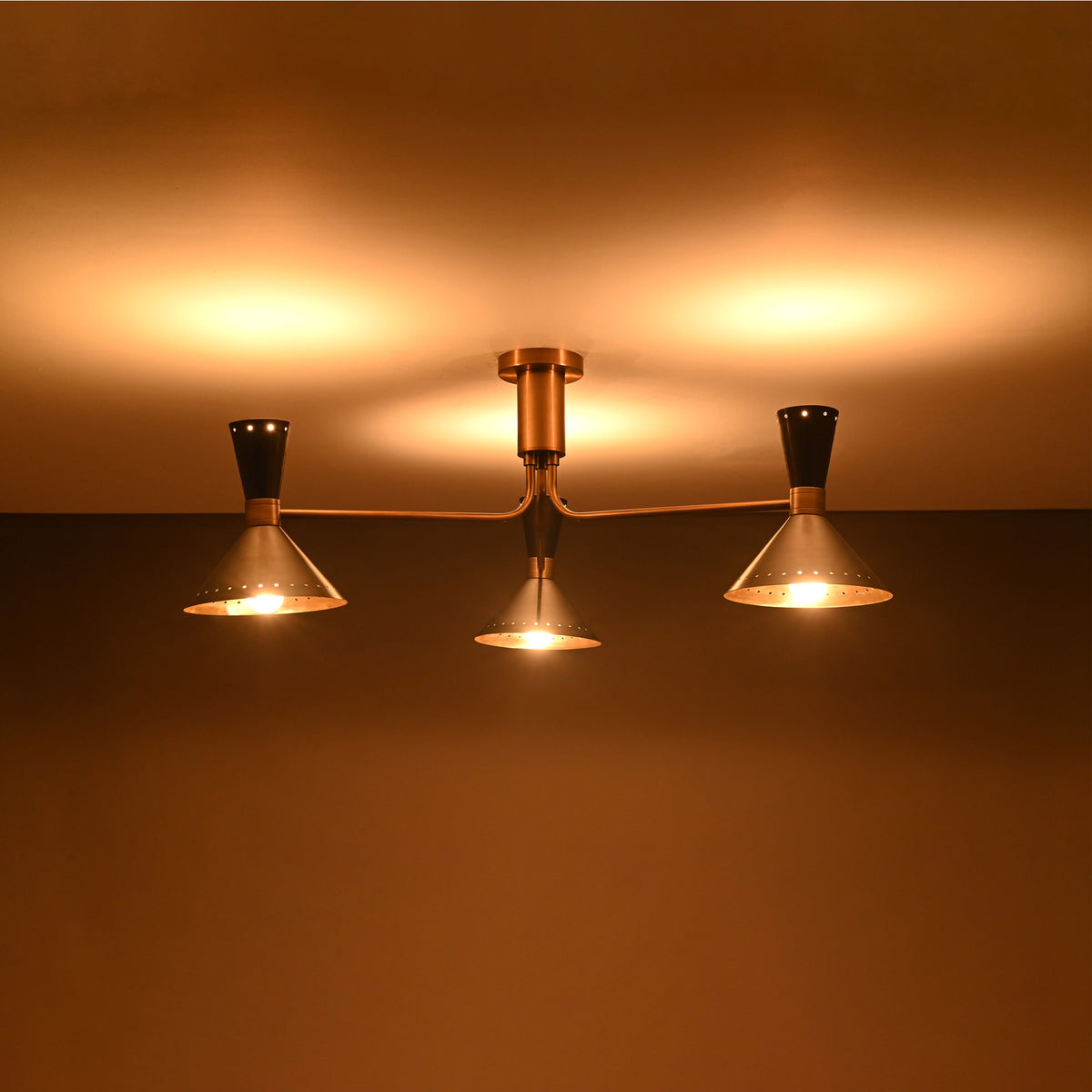 Close up of Oslo Cone Arm Chandelier showing cone shades, slim arms, and refined ceiling canopy.