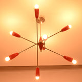Bottom illuminated view of the Oslo Modern Cone Sputnik Chandelier featuring exposed globe bulbs, red cone shades, brushed nickel arms, and geometric Mid-Century Modern design.