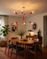 Oslo Modern Cone Sputnik Chandelier installed above a modern wooden dining table, featuring eight red cone shades, brushed nickel frame, warm ambient lighting, and Mid-Century Modern interior styling.