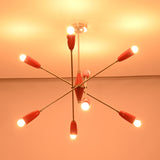 Low-angle illuminated view of the Oslo Modern Cone Sputnik Chandelier displaying red tapered cone shades, brushed nickel finish, exposed bulbs, and iconic Sputnik configuration.