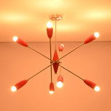 Symmetrical illuminated view of the Oslo Modern Cone Sputnik Chandelier with eight red cone shades, brushed nickel frame, exposed globe bulbs, and contemporary Mid-Century appeal.