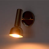 Angled illuminated view of Oslo modern polished nickel adjustable reading sconce with swivel-mounted cylindrical shade and concentrated beam of light.