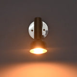 Front view of Oslo modern polished nickel reading wall light with handcrafted cylindrical shade delivering warm focused illumination.