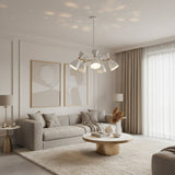 Oslo 5 light perforated cone chandelier with white double cone shades and brass accents, illuminated angled view.