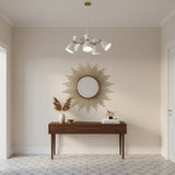 Angled view of Oslo 5 light chandelier with sculptural white perforated cone shades and brass radial frame.