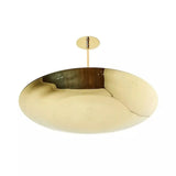 Oslo 5 light brass chandelier close-up highlighting the reflective metal disc shade and sculptural curved profile.