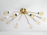 Oslo Sputnik flush mount chandelier featuring ten radial arms, white cylindrical sockets, and a compact Mid-Century Modern design.