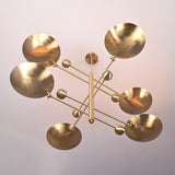 Angled view of Palermo Orbital chandelier featuring six sculptural disc shades and offset linear arms.