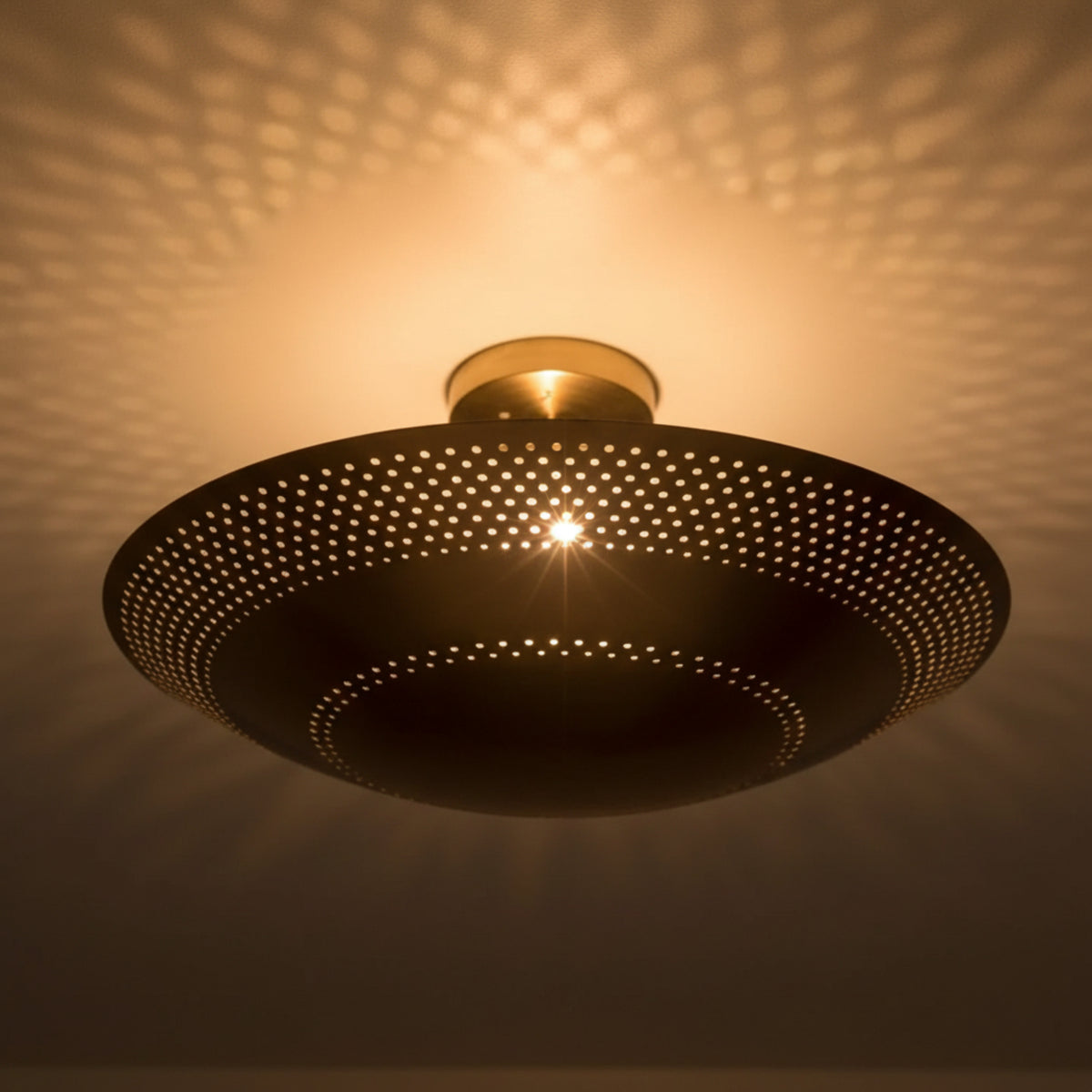 Palermo 5 light brass tone bowl chandelier close-up showing the detailed perforated metal design and curved profile.