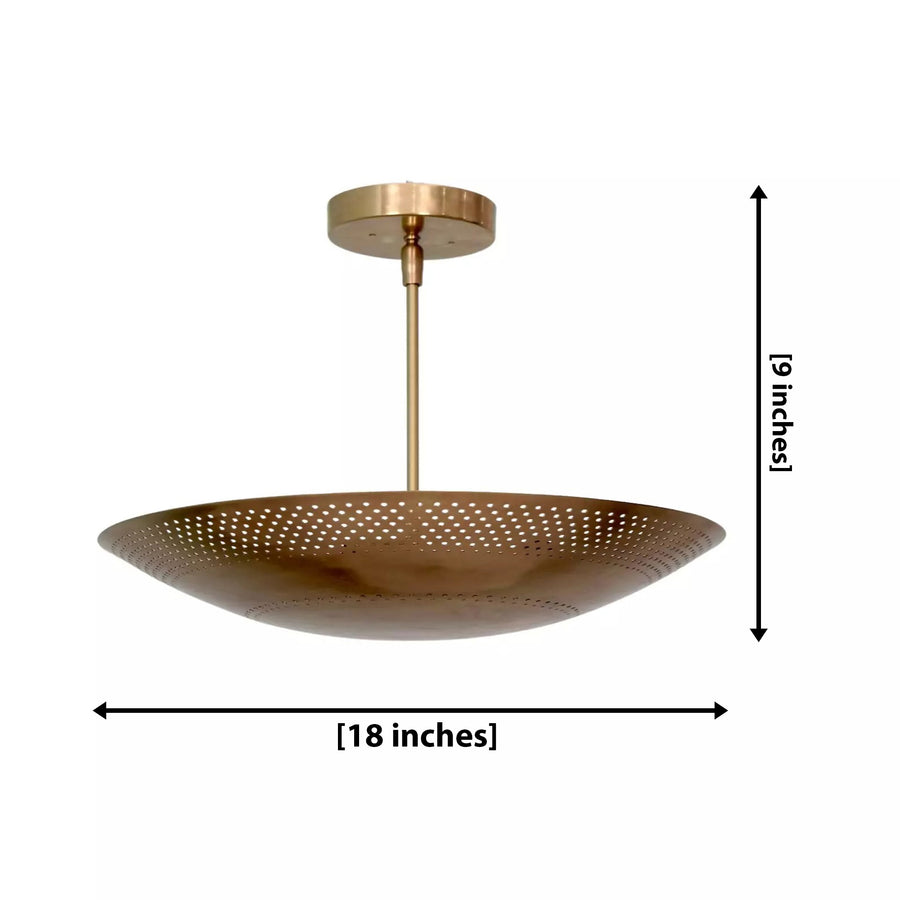 Palermo 5 light brass tone perforated bowl chandelier installed in a modern living room with warm ambient lighting.