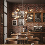 Paris 12 light polished metal Sputnik chandelier shown from an angled perspective with illuminated Edison bulbs.