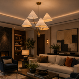 Perth 5 light cream cone shade chandelier illuminated in a sophisticated modern living room with warm ambient lighting.