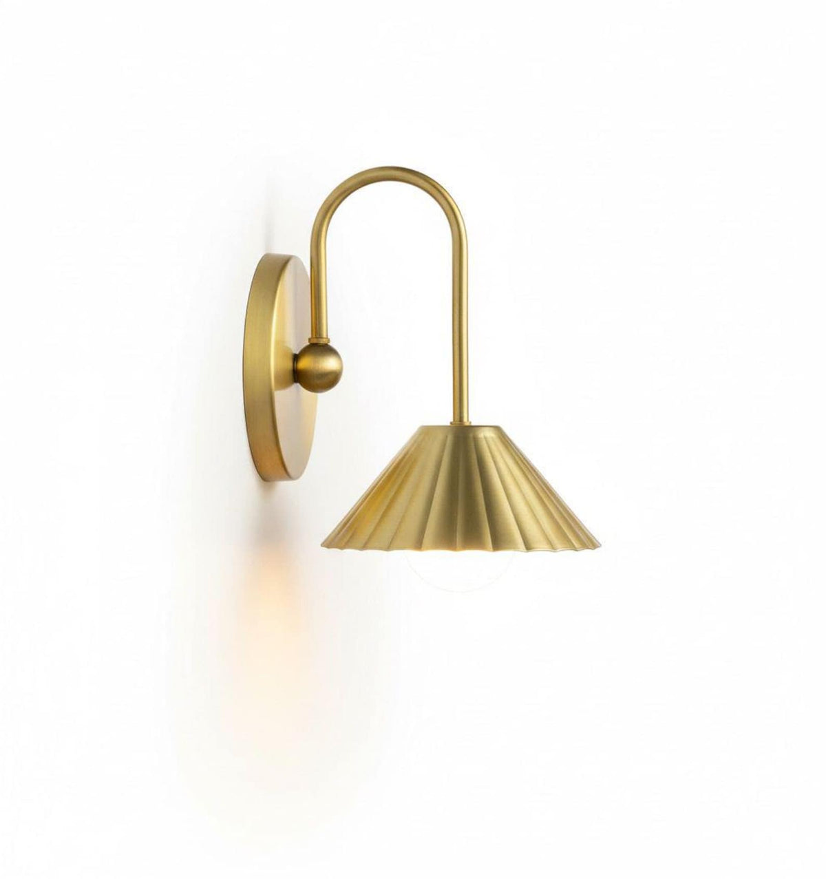 Straight front view of handcrafted brass wall light with pleated dome shade and exposed globe bulb