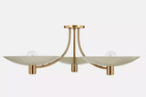 Positano 3-light semi-flush mount chandelier installed on a white ceiling, showcasing elegant ivory saucer shades, curved brass arms, and a low-profile sculptural design.