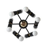 Prague 12 light sculptural chandelier shown from the top with black cylindrical holders, radial arms, brass-tone accents, and exposed white bulbs.