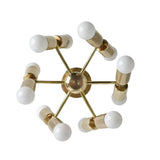 Prague 12 light sculptural chandelier shown from the top with brass-tone radial arms, cylindrical holders, and exposed white bulbs.