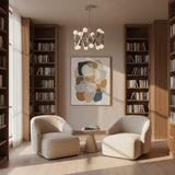 Prague 12 light Mid-Century Modern chandelier shown from the front with polished silver-tone cylindrical holders and multidirectional exposed bulbs.