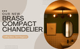 Advertisement for a brass compact chandelier with a bathroom setting in the background.