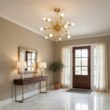 Provence 8 light brass tone Sputnik chandelier featuring a sculptural starburst design with radiating rods and globe bulbs.