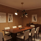 Queenstown 6 light Mid-Century Modern chandelier shown from the front with black perforated cone shades and brass-tone sculptural arms.