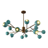 Illuminated Ravenna 15-light chandelier showcasing glossy turquoise shades, warm glowing bulbs, and elegant brass-tone multi-arm construction.