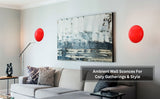 Modern living room with sofa and wall art, decorated with two red disc wall sconces casting soft ambient glow