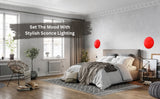 Modern bedroom with a pair of red disc wall sconces above bed, creating stylish ambient mood lighting