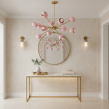 Rhodes 12 light Sputnik chandelier highlighting the polished brass center, radiating arms and soft pink globe shades.