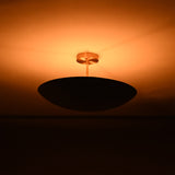 Side view of Rome Disc semi-flush ceiling light creating soft warm ambiance with a low-profile disc design.
