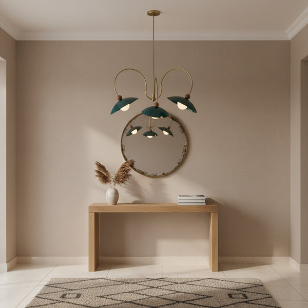 Rouen 3 light teal dome chandelier shown illuminated from below with warm glowing globe bulbs and brass-tone curved arms.