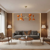 Saint Tropez 12 light orange Sputnik chandelier featuring sculptural double-cone metal shades and a brass-tone radial frame on a white background.