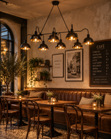 Santander 8 light black dome chandelier displayed above tables in a warm vintage-inspired café interior.
