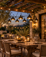 Santander 8 light black dome chandelier illuminating a covered outdoor dining area with warm evening ambiance.