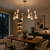 Santander 12 light brass and white cone chandelier illuminated above a modern dining table in an elegant dining room.