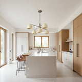 Savannah 5 light sculptural chandelier shown from the front with cream rounded shades and warm bronze-tone multi-arm frame.
