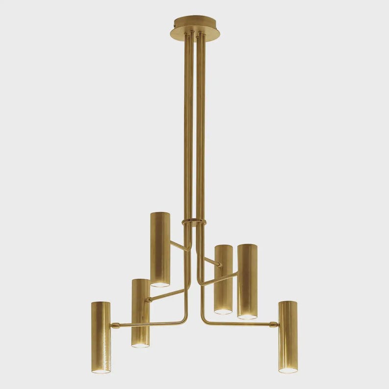 Sculptural brass chandelier with six cylindrical shades and architectural arms, handcrafted in solid brass by Brass Leaf Studio.