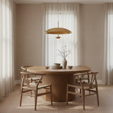Seville 3 light Mid-Century Modern disc chandelier shown from an angled view highlighting its oversized circular form and warm brass-tone detailing.