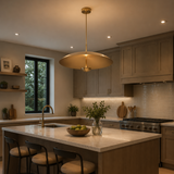 Seville 3 light sculptural disc chandelier installed above a modern kitchen island with warm ambient lighting and contemporary cabinetry.