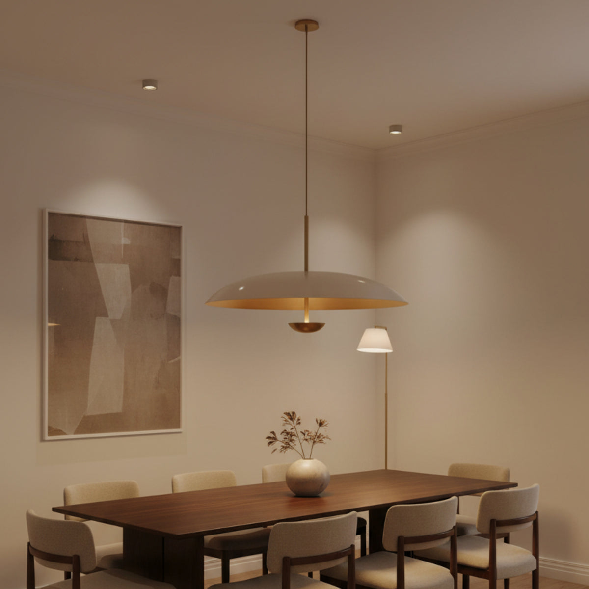 Seville 3 light minimalist disc chandelier shown in profile with its broad curved shade, slim suspension, and warm metallic interior.