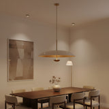 Seville 3 light minimalist disc chandelier shown in profile with its broad curved shade, slim suspension, and warm metallic interior.