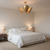 Shanghai 3 light sculptural chandelier shown from an alternate front view highlighting its curved brass-tone petals and floral-inspired silhouette.