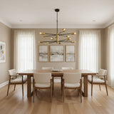 Siena 12 light black and brass Sputnik chandelier shown unlit with multidirectional arms, exposed bulbs, downrod, and ceiling canopy.
