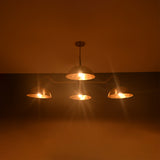 Siena Curved Arm chandelier installed above a kitchen dining table, creating warm Mid-Century Modern ambiance.