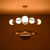 Siena Globe Disc Chandelier side view showing glowing globe lights, circular arm frame, and warm ceiling illumination.