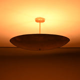 Siena Single Disc Chandelier close-up with glowing ceiling effect and dramatic low-profile bowl silhouette.