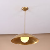 Modern brass pendant lamp featuring dome-shaped shade and warm upward glow, handmade lighting design