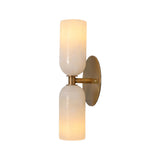 Front illuminated view of the Sloane Double Cylinder Alabaster Wall Sconce in solid brass featuring handcrafted natural alabaster cylinder shades.